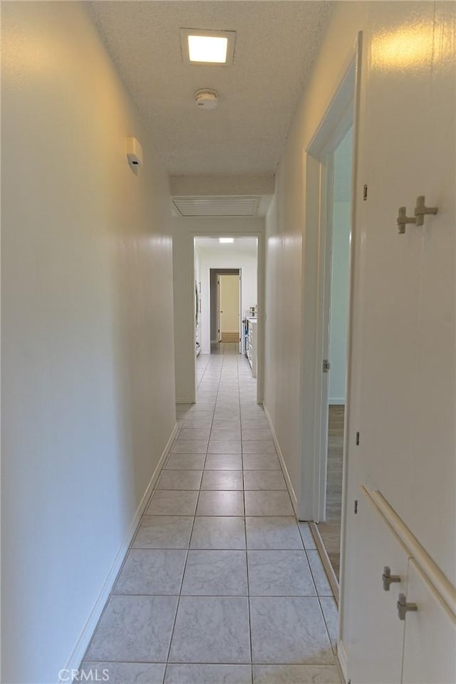 12406 Benson Ave, Chino, CA 91710 - corridor featuring light tile patterned flooring and baseboards