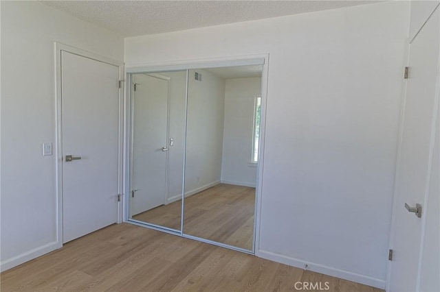 12406 Benson Ave, Chino, CA 91710 - unfurnished bedroom with wood finished floors, a closet, and baseboards