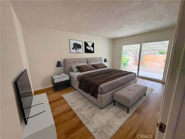 12406 Benson Ave, Chino, CA 91710 - bedroom with access to outside, wood finished floors, and baseboards
