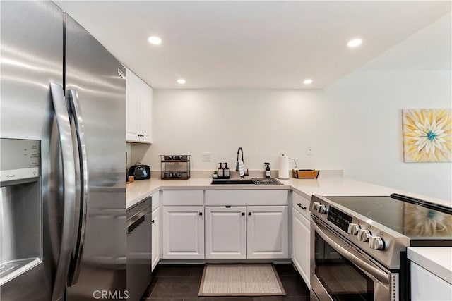 280 S Avenida Caballeros Unit 266, Palm Springs, CA 92262 - kitchen featuring appliances with stainless steel finishes, a sink, dark tile patterned flooring, white cabinets, and recessed lighting