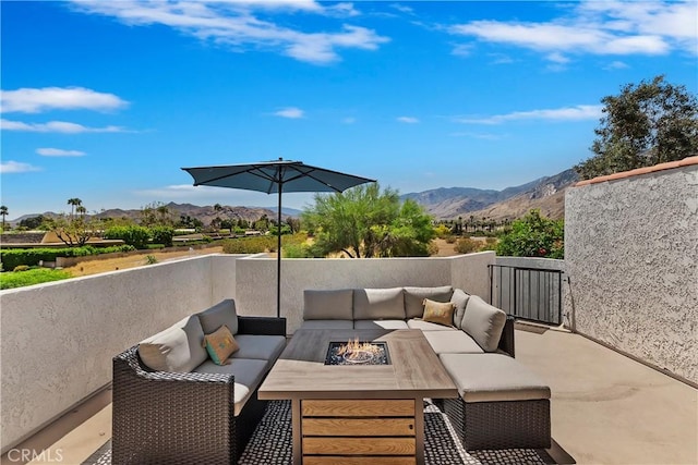280 S Avenida Caballeros Unit 266, Palm Springs, CA 92262 - view of patio / terrace with a mountain view and an outdoor living space with a fire pit