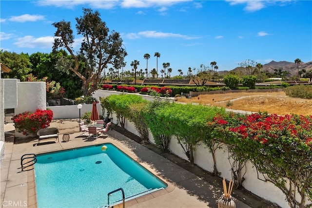 280 S Avenida Caballeros Unit 266, Palm Springs, CA 92262 - view of swimming pool with a patio area, a mountain view, and a fenced backyard