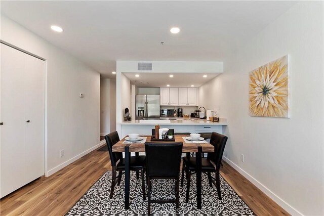 280 S Avenida Caballeros Unit 266, Palm Springs, CA 92262 - dining room featuring light wood-style flooring, baseboards, and recessed lighting