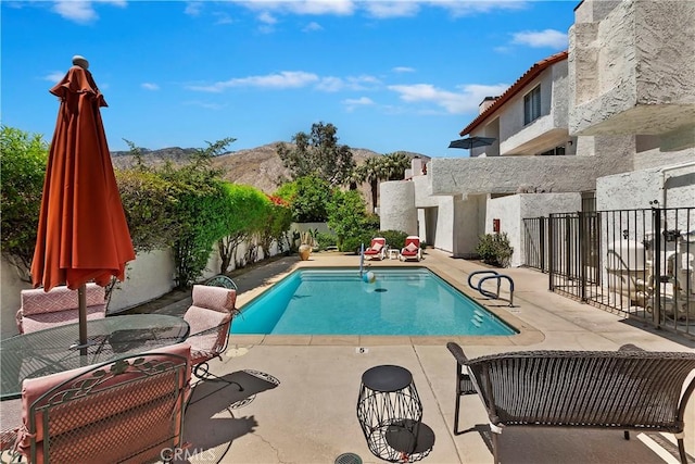 280 S Avenida Caballeros Unit 266, Palm Springs, CA 92262 - view of swimming pool with a patio, a mountain view, and fence
