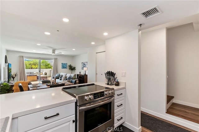 280 S Avenida Caballeros Unit 266, Palm Springs, CA 92262 - kitchen with electric range, light countertops, white cabinetry, wood finished floors, and recessed lighting