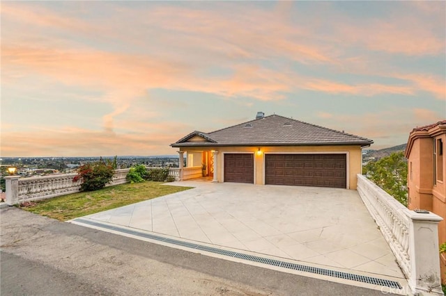 12336 Circula Panorama, North Tustin, CA 92705 - view of front of property featuring a garage, driveway, a tiled roof, and stucco siding