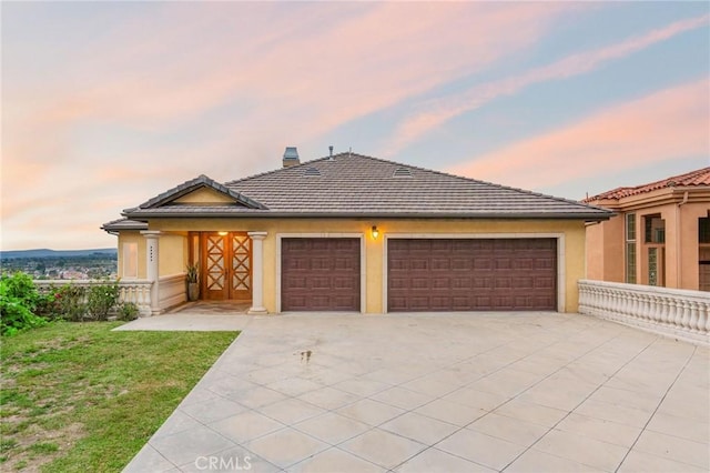 12336 Circula Panorama, North Tustin, CA 92705 - view of front of house featuring stucco siding, driveway, a garage, a chimney, and a front yard