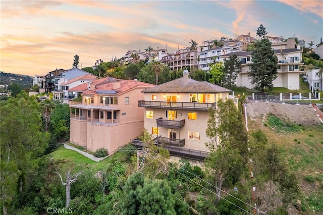 12336 Circula Panorama, North Tustin, CA 92705 - back of house featuring a balcony, stucco siding, a residential view, and a chimney