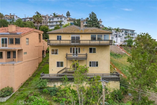 12336 Circula Panorama, North Tustin, CA 92705 - rear view of house featuring a balcony, stucco siding, a residential view, and a chimney