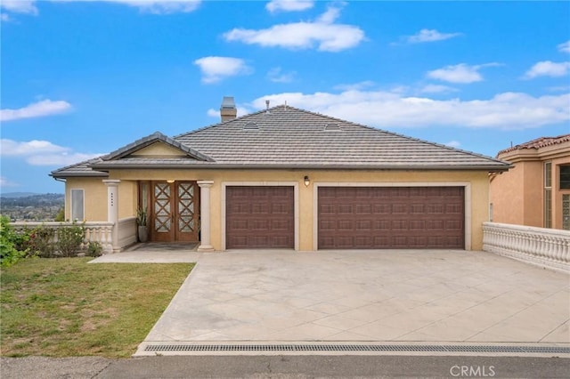 12336 Circula Panorama, North Tustin, CA 92705 - view of front of home with driveway, stucco siding, an attached garage, a front yard, and a chimney