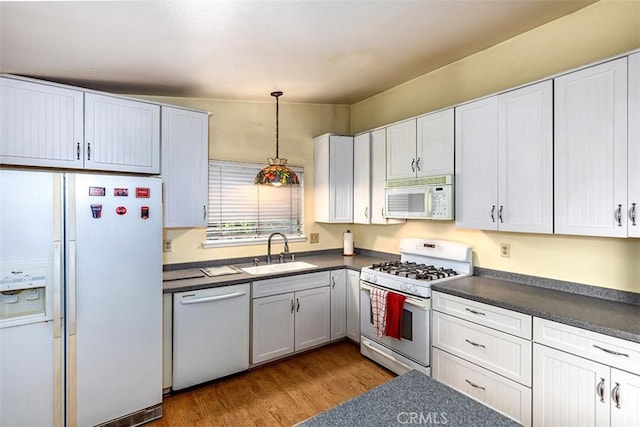 1803 Blue Haven Dr, Rowland Heights, CA 91748 - kitchen featuring white appliances, a sink, dark countertops, and wood finished floors