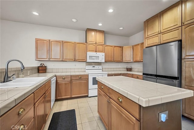 kitchen with white appliances, a sink, tile countertops, light tile patterned floors, and recessed lighting