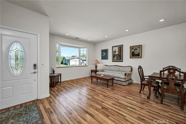 foyer entrance with light wood-type flooring, baseboards, and recessed lighting