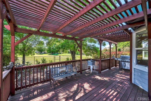 wooden deck featuring a fenced backyard, a pergola, and a grill