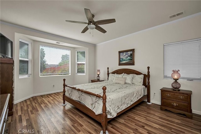 bedroom with wood finished floors, ornamental molding, baseboards, and ceiling fan