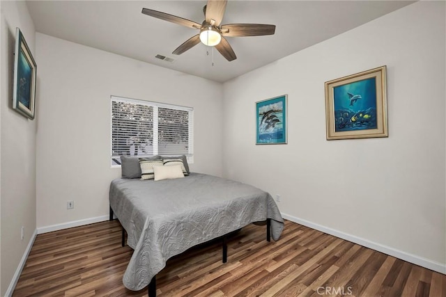 bedroom with baseboards, wood finished floors, and a ceiling fan