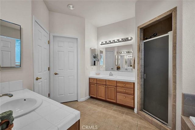 full bath featuring a stall shower, tile patterned flooring, and two vanities