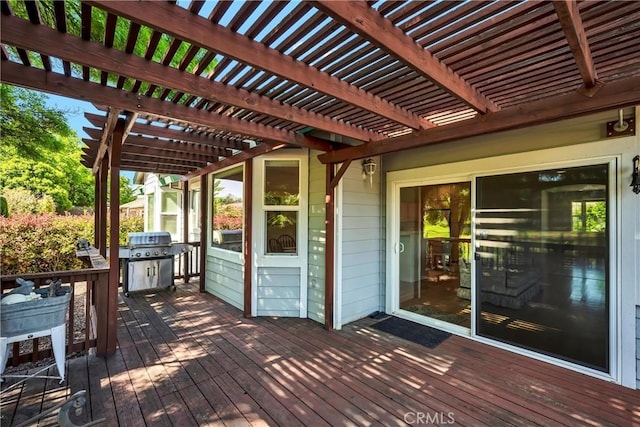 wooden terrace featuring a pergola and a grill