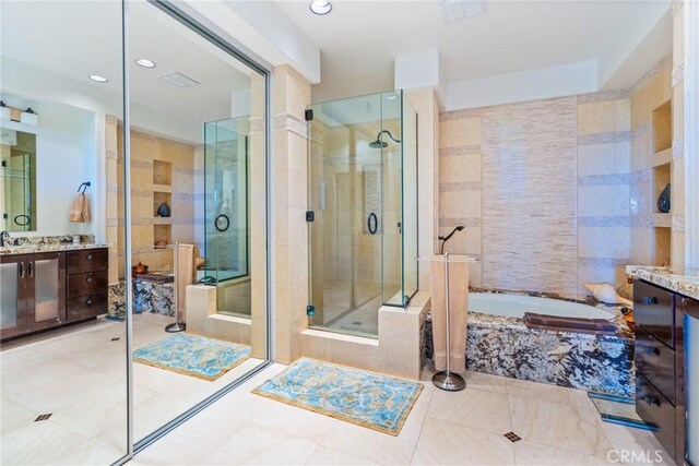 bathroom with a shower stall, vanity, a garden tub, tile patterned flooring, and recessed lighting
