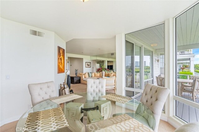 carpeted dining space featuring baseboards