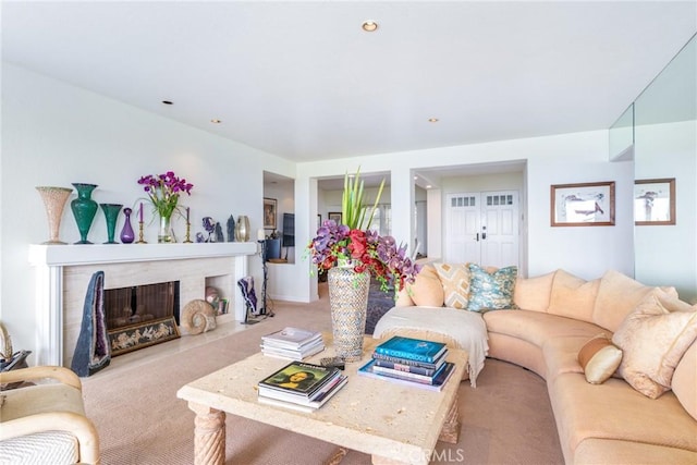 living area featuring carpet flooring and a fireplace