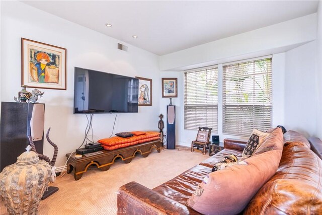 carpeted living room featuring baseboards and recessed lighting