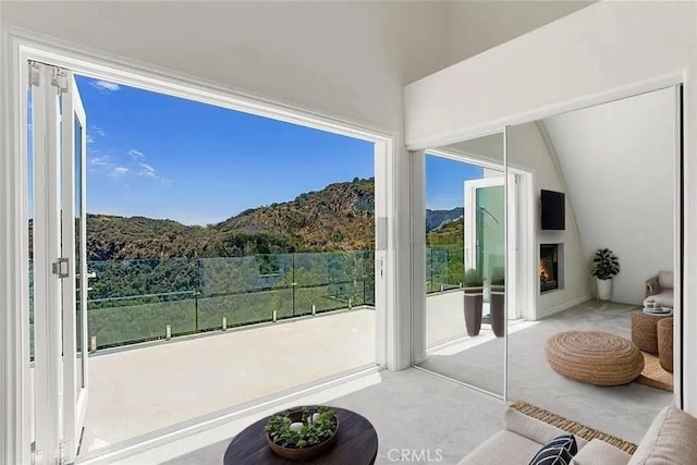 entryway with a fireplace and lofted ceiling