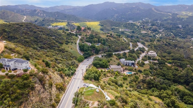 aerial view of property and surrounding area featuring a mountain backdrop