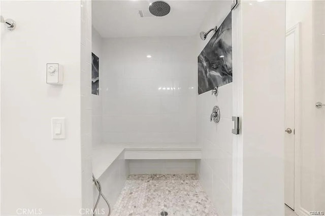 full bathroom with a tile shower