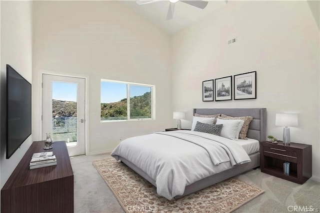 bedroom featuring light colored carpet, access to outside, baseboards, high vaulted ceiling, and a ceiling fan