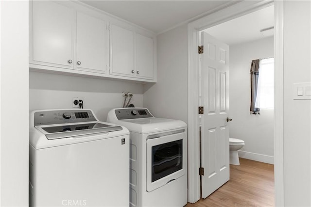 20011 Colgate Cir, Huntington Beach, CA 92646 - laundry area featuring separate washer and dryer, cabinet space, light wood-style flooring, and baseboards