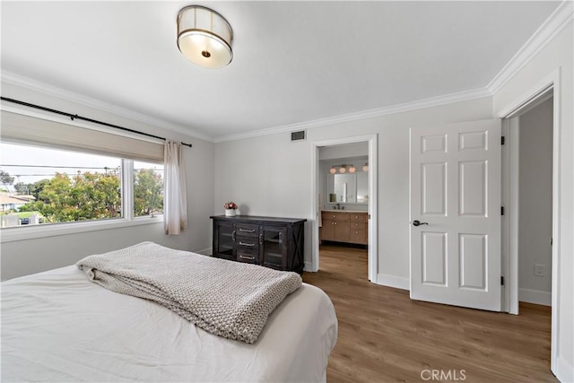 20011 Colgate Cir, Huntington Beach, CA 92646 - bedroom with crown molding, wood finished floors, baseboards, and ensuite bathroom