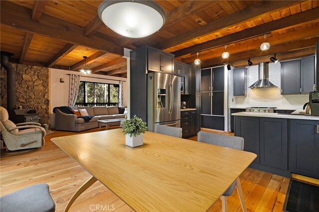 14315 Troy Way, Magalia, CA 95954 - dining room with wooden ceiling, light wood-type flooring, a wood stove, and beam ceiling