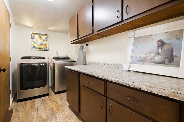 14315 Troy Way, Magalia, CA 95954 - laundry room featuring separate washer and dryer, light wood-style floors, and cabinet space