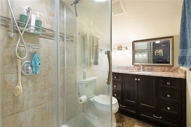 14315 Troy Way, Magalia, CA 95954 - bathroom featuring a shower stall, toilet, vanity, and wood finished floors