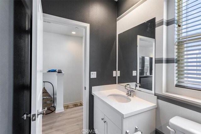 177 Frame, Irvine, CA 92618 - half bath featuring vanity, toilet, and wood finished floors
