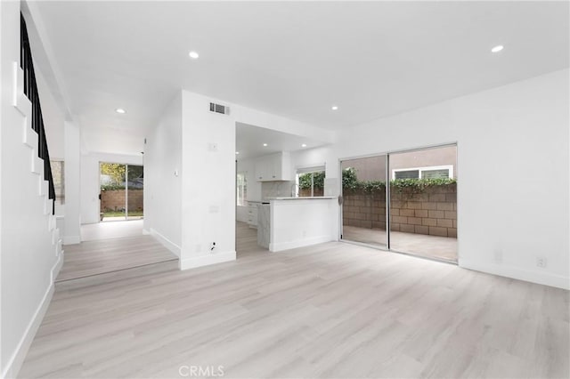 12029 Bubbling Brook St, Moorpark, CA 93021 - unfurnished living room with light wood-style floors, recessed lighting, and baseboards