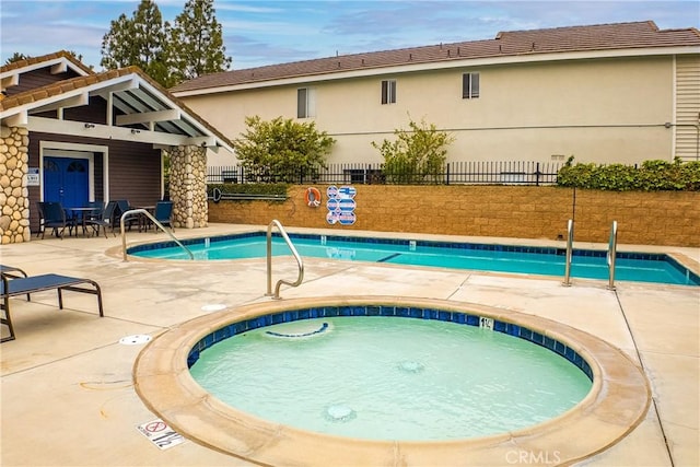 12029 Bubbling Brook St, Moorpark, CA 93021 - community pool featuring fence, a hot tub, and a patio area