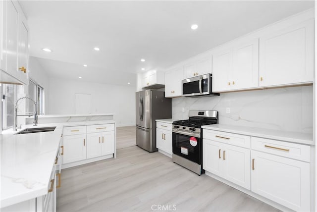 12029 Bubbling Brook St, Moorpark, CA 93021 - kitchen featuring stainless steel appliances, a sink, light wood-type flooring, white cabinetry, and recessed lighting