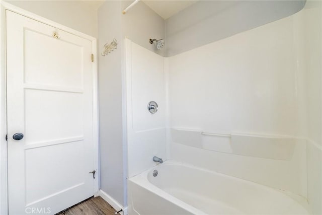 3465 Sepulveda Ave, San Bernardino, CA 92404 - bathroom featuring baseboards, bathtub / shower combination, and wood finished floors