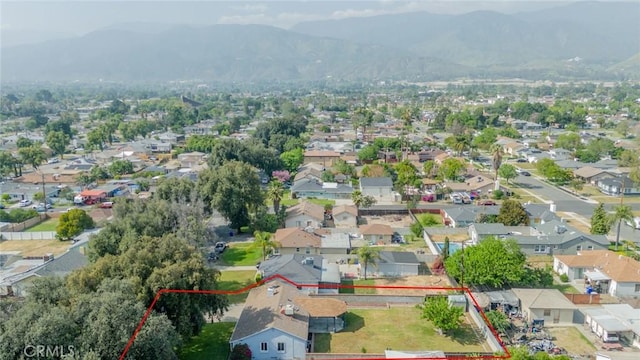 3465 Sepulveda Ave, San Bernardino, CA 92404 - aerial perspective of suburban area with property boundaries highlighted and a mountain backdrop