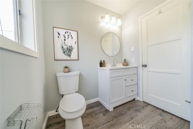 3465 Sepulveda Ave, San Bernardino, CA 92404 - bathroom featuring wood finished floors, toilet, vanity, and baseboards