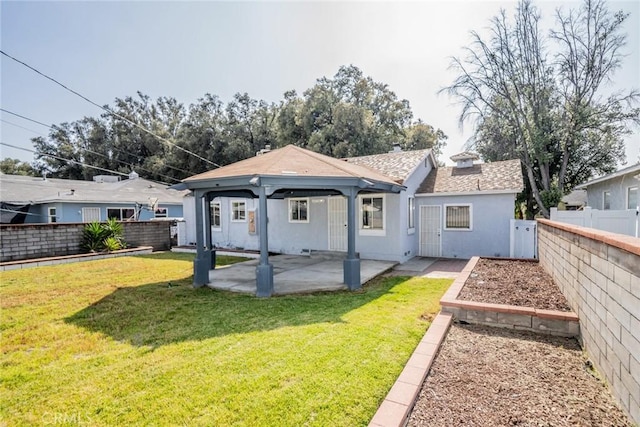 3465 Sepulveda Ave, San Bernardino, CA 92404 - back of property with a gazebo, a patio area, stucco siding, and a shingled roof