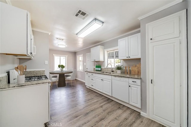 3465 Sepulveda Ave, San Bernardino, CA 92404 - kitchen featuring a sink, white dishwasher, light wood-style floors, white cabinetry, and ornamental molding
