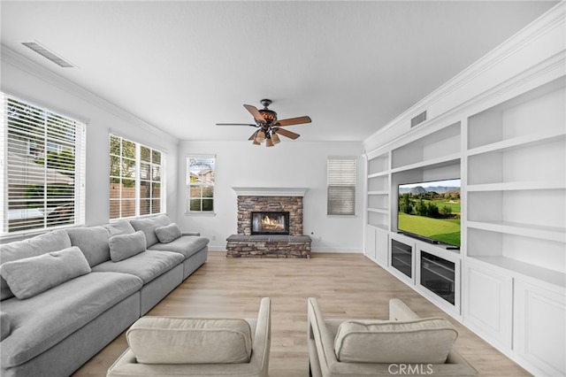 living room featuring ornamental molding, a ceiling fan, baseboards, light wood-type flooring, and built in features