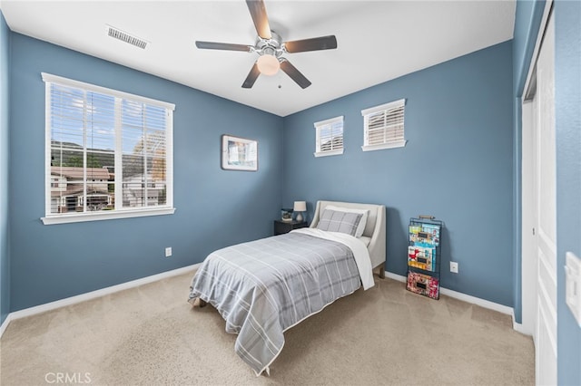 carpeted bedroom with baseboards and ceiling fan
