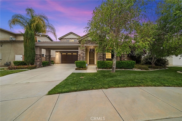 view of front of home featuring concrete driveway, a front yard, stone siding, stucco siding, and an attached garage