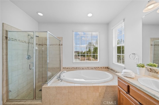 full bathroom with a shower stall, a garden tub, vanity, and recessed lighting