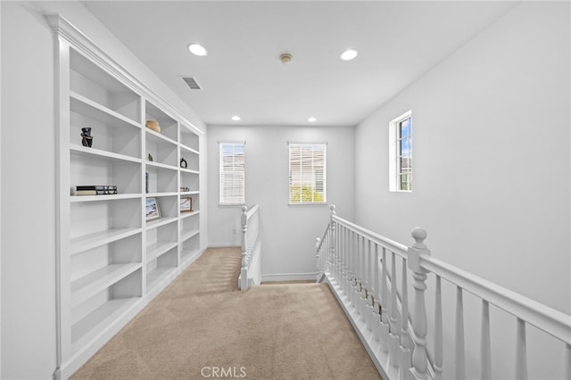 corridor with an upstairs landing, recessed lighting, carpet flooring, and baseboards