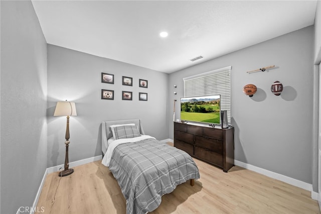 bedroom featuring light wood-style flooring and baseboards